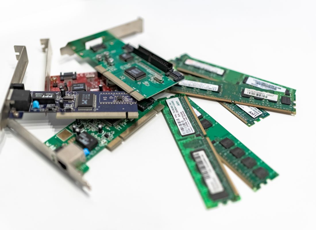 Recovered computer components — memory modules and expansion cards — from dismantled IT assets